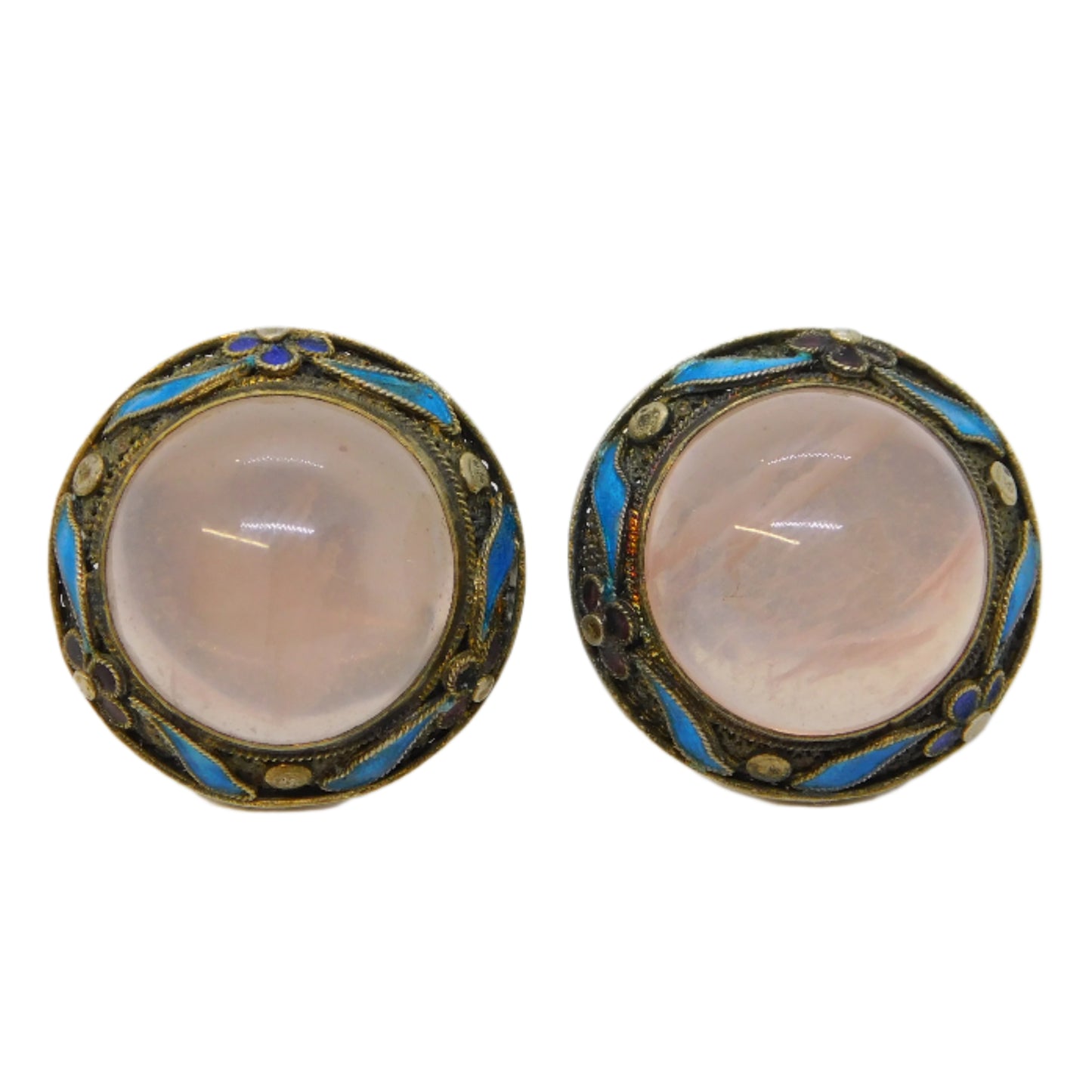 Pair of vintage earrings with pink stones on a white background