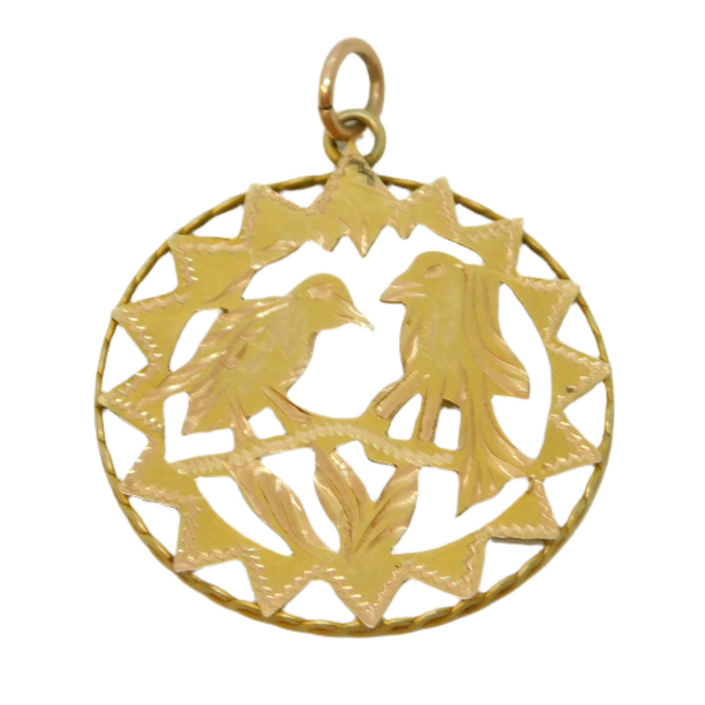 Gold pendant with intricate design on a light gray background