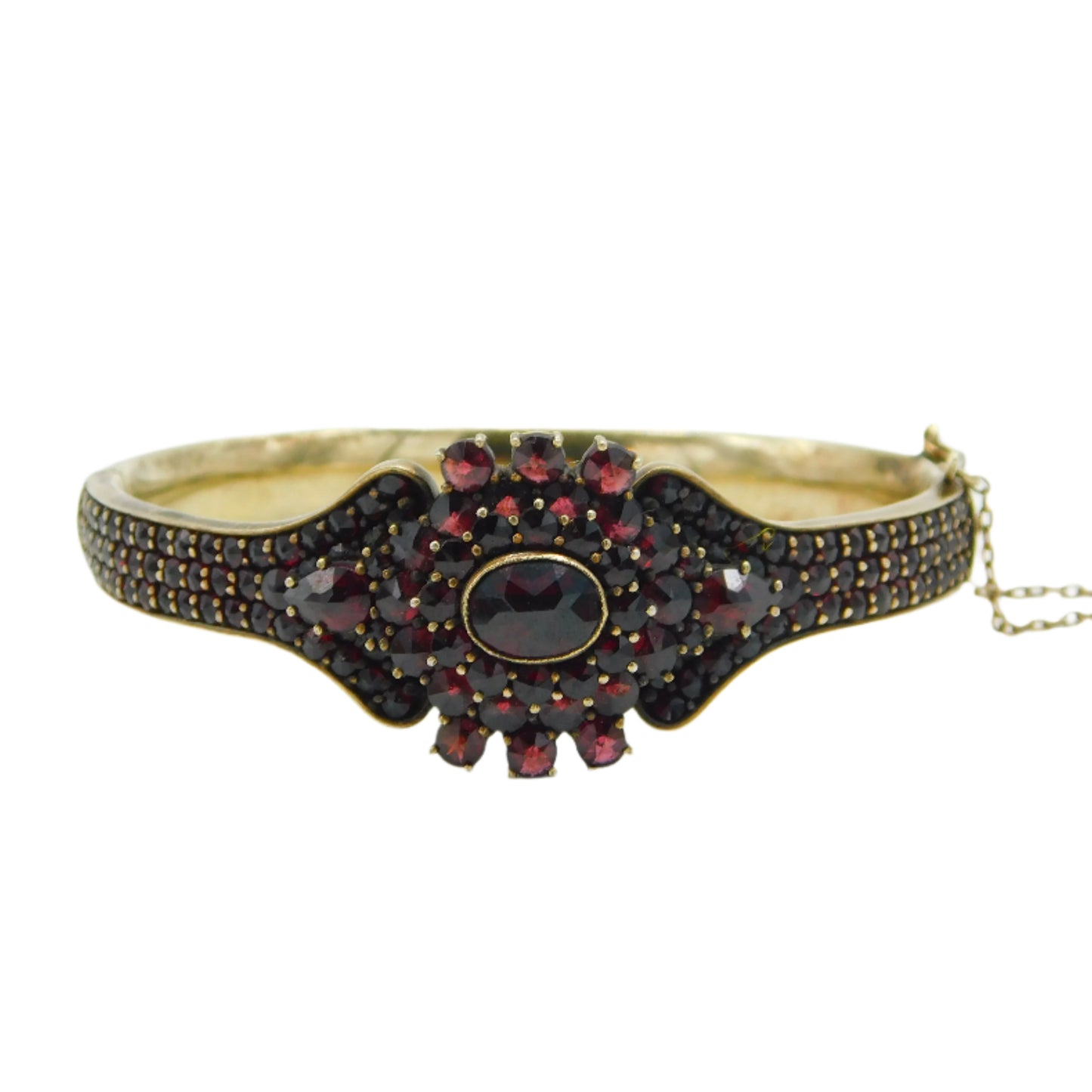 Gold bracelet with red gemstones on a white background