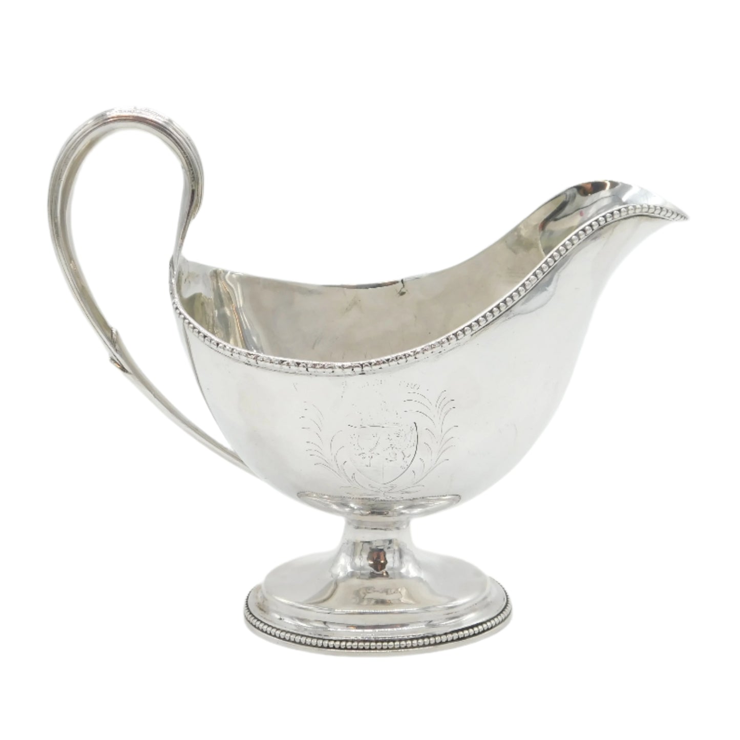 Silver gravy boat on a white background