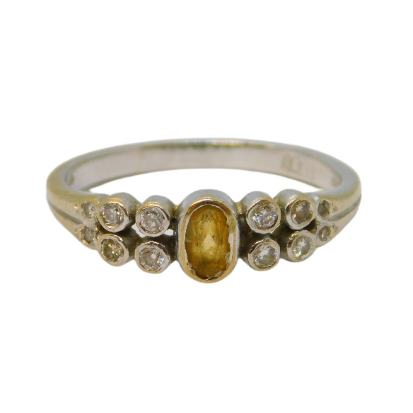Gold ring with a central gemstone and smaller diamonds on a white background