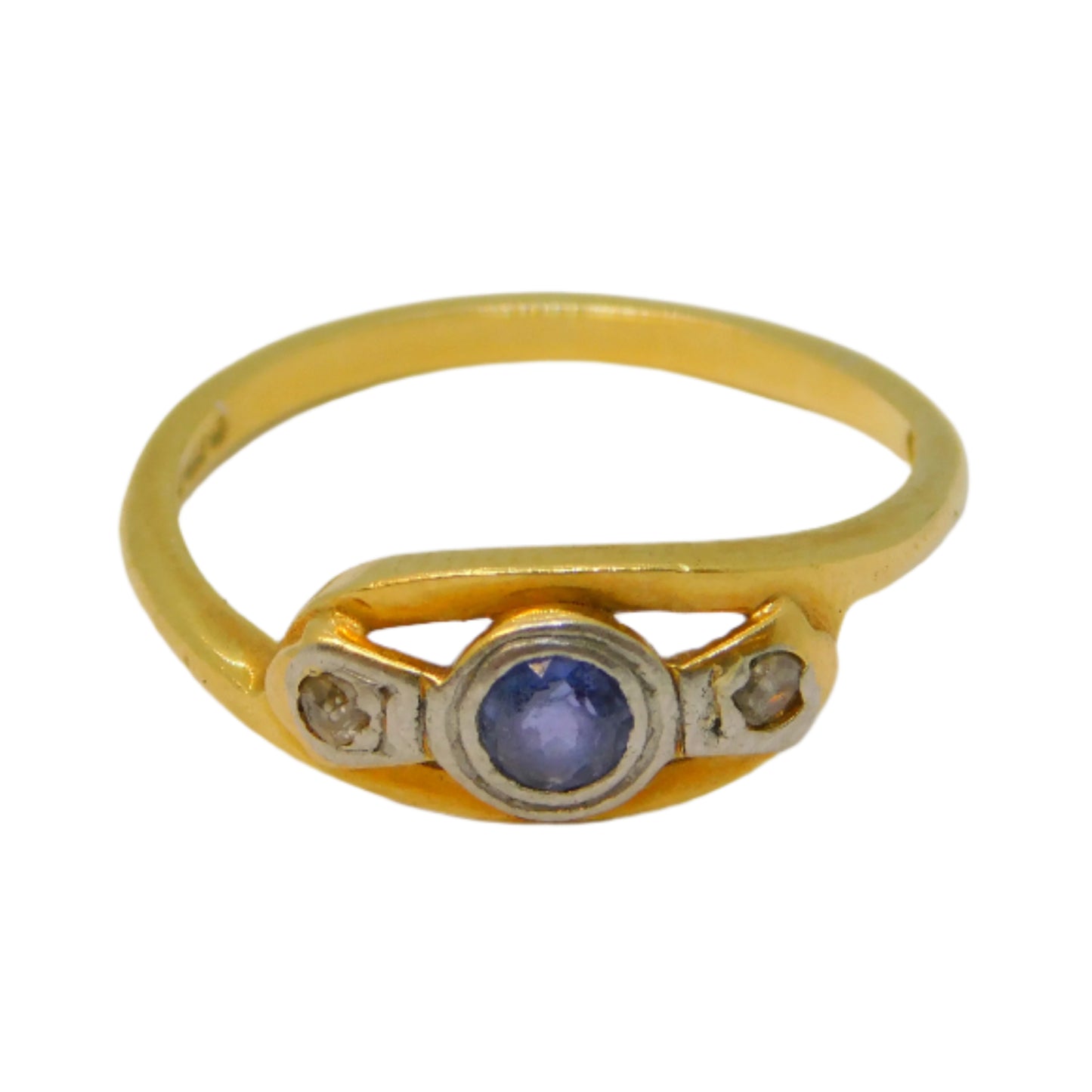 Gold ring with a central gemstone on a white background
