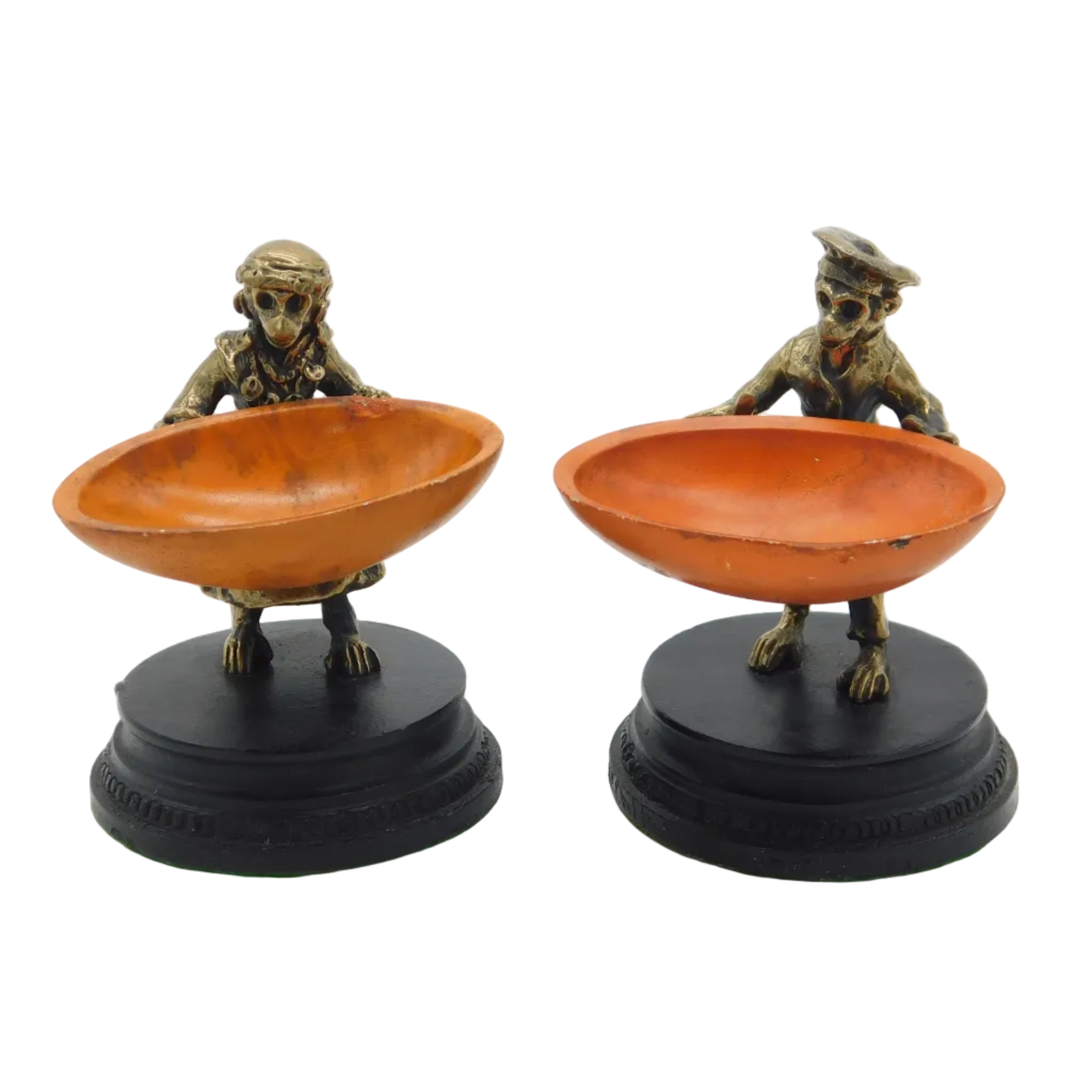 A pair of Victorian bronze novelty salt cellars depicting monkeys holding large dishes, set on black wooden plinth bases.