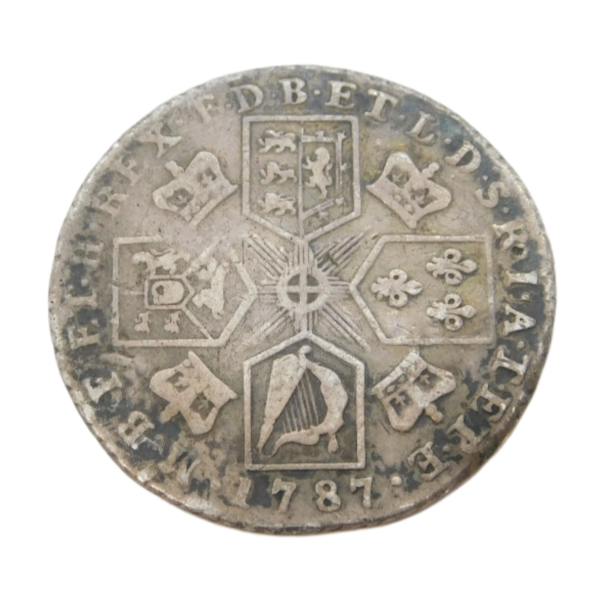 Old silver coin with intricate designs on a white background