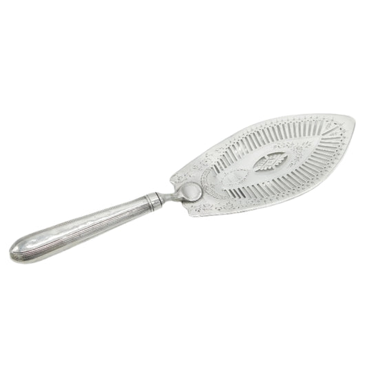 Silver cake server with decorative handle on a light gray background