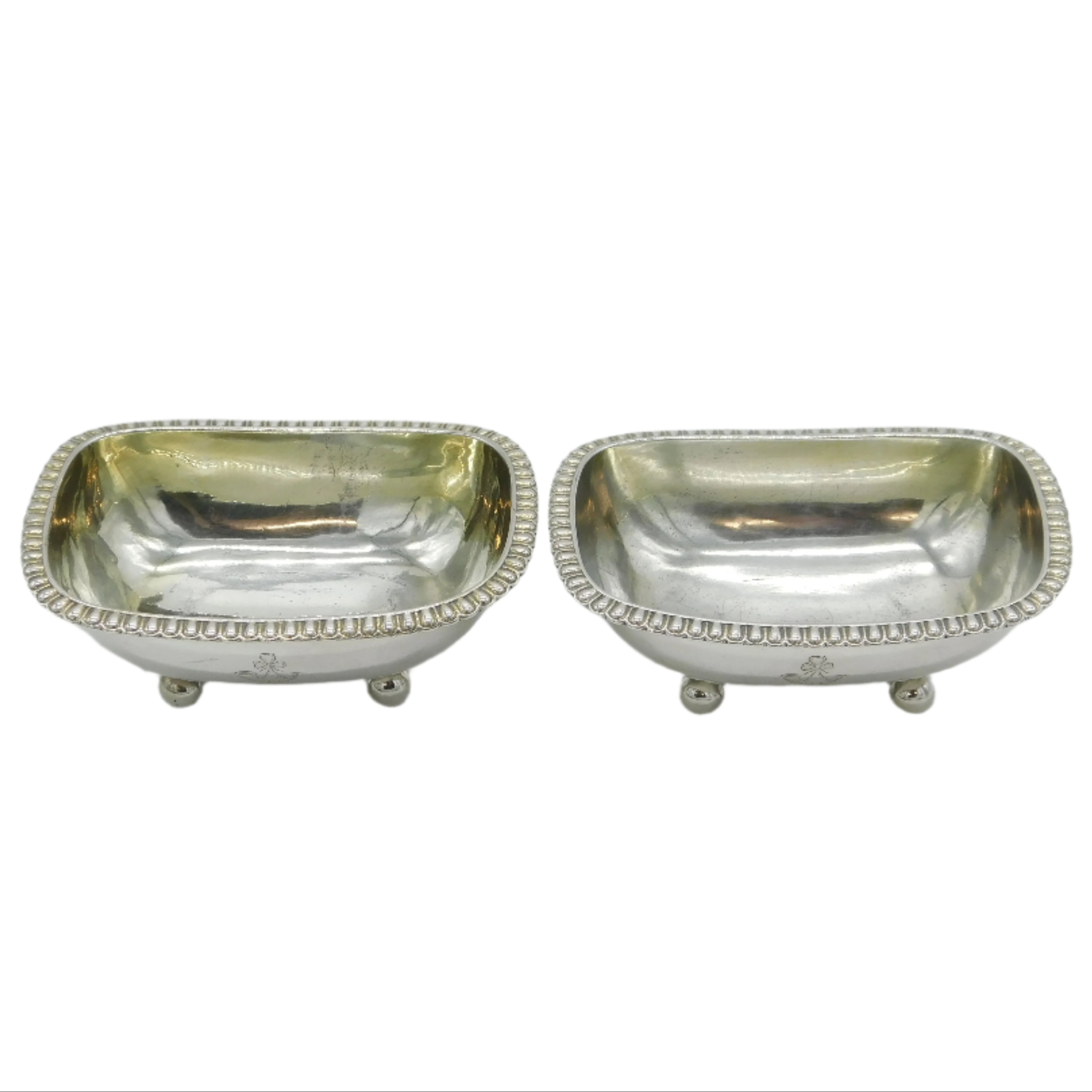 Two silver salt shakers on a white background