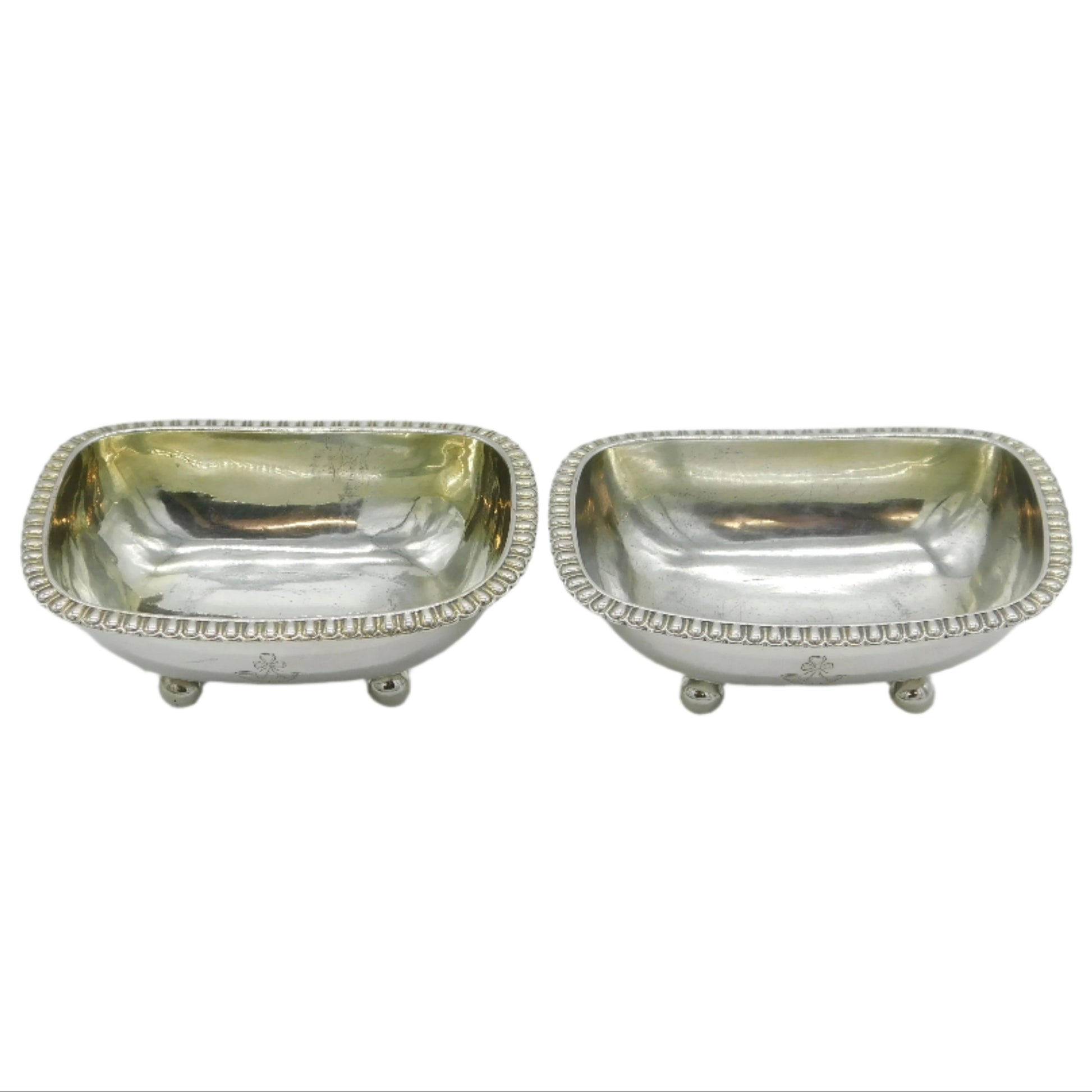 Two silver salt shakers on a white background