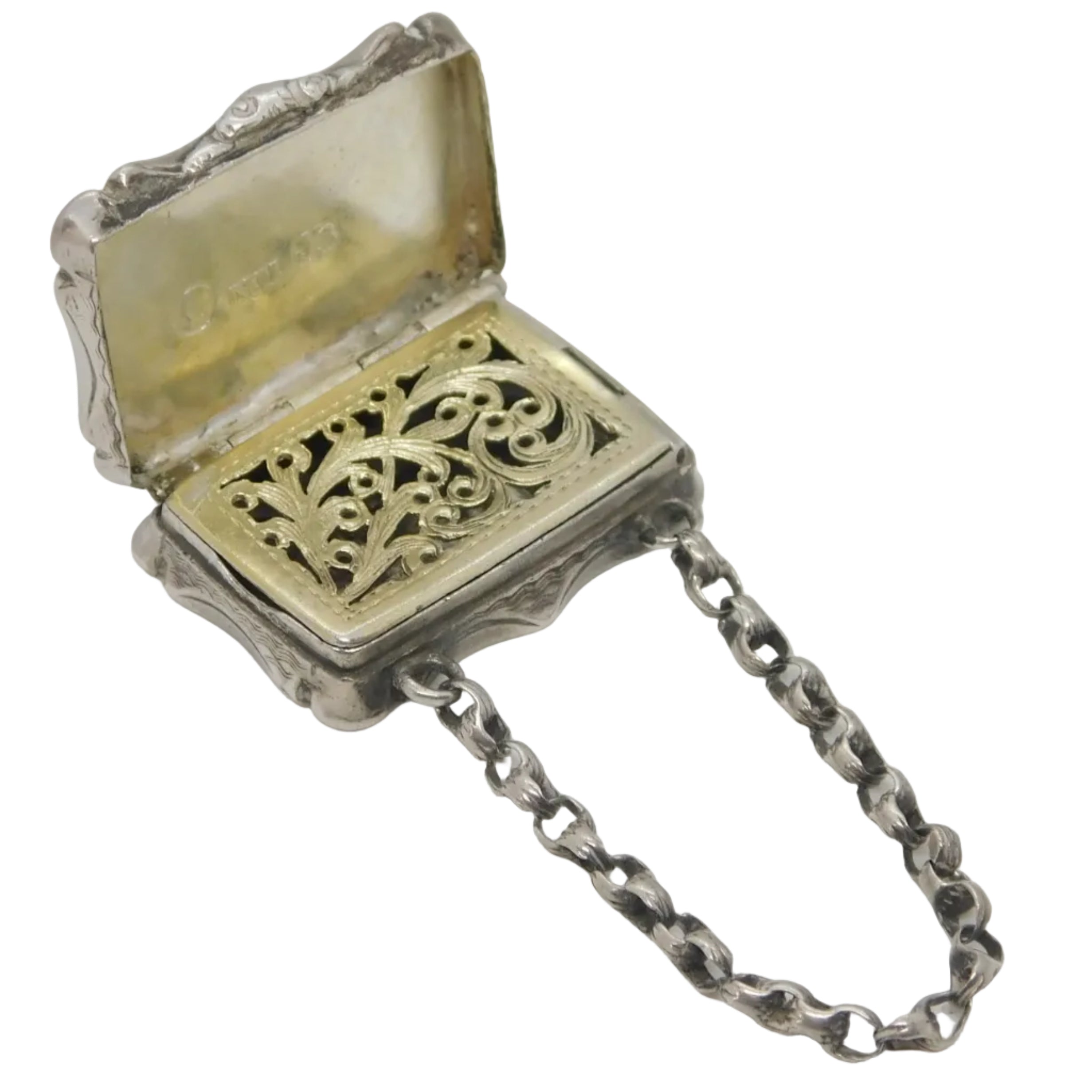 Antique Victorian sterling silver purse vinaigrette with lion crest, partially open, showing the interior gilding and the chain attached to the bottom.