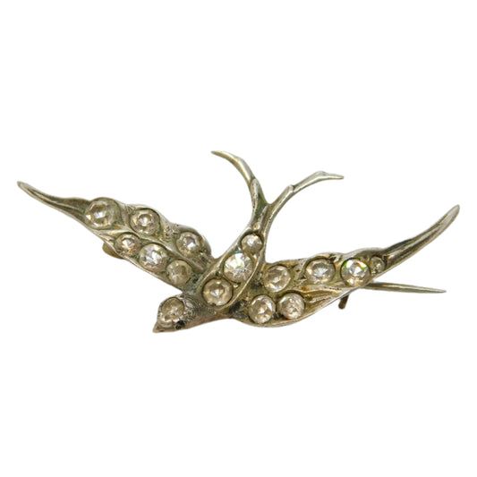 Gold brooch with gemstones on a white background