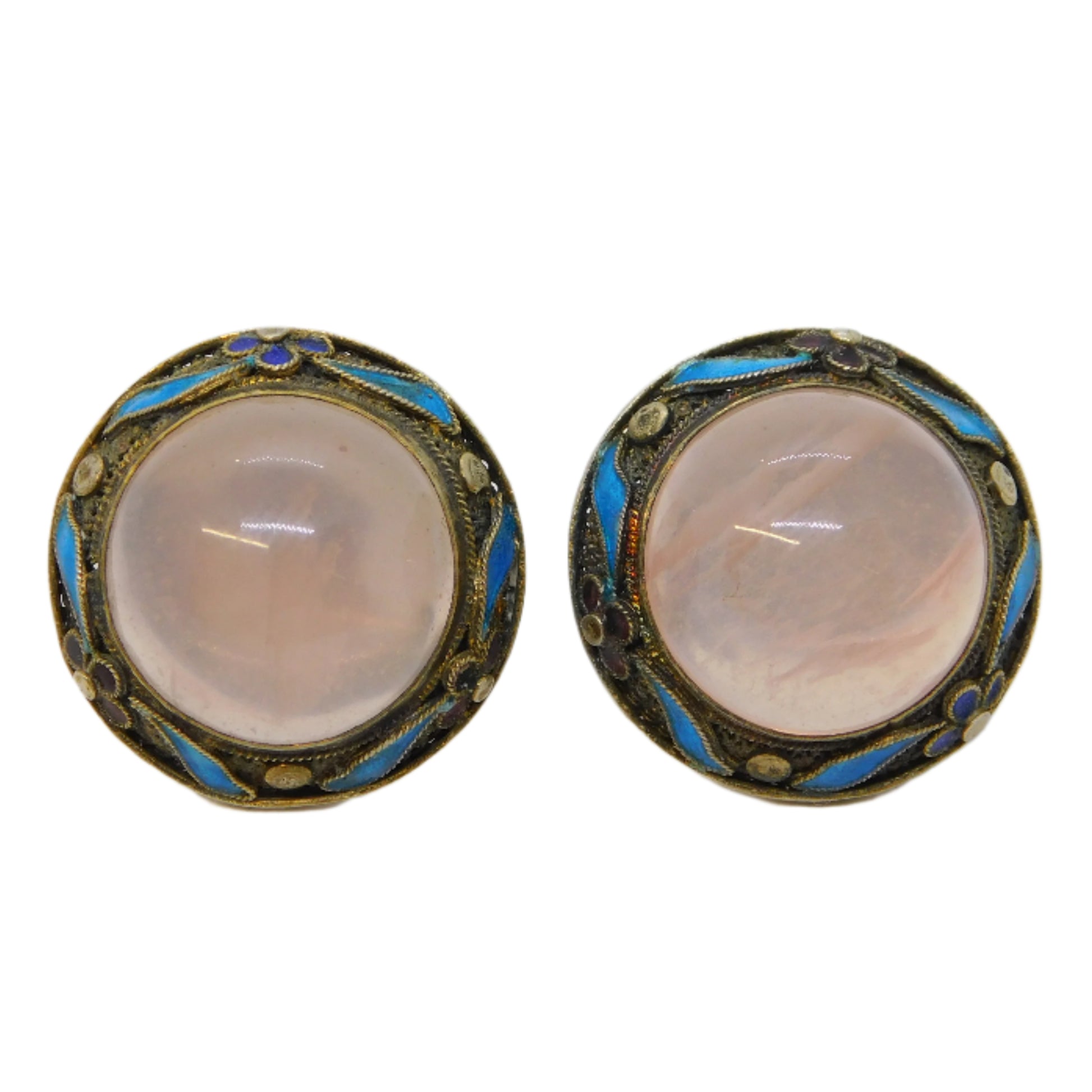 Pair of vintage earrings with pink stones on a white background