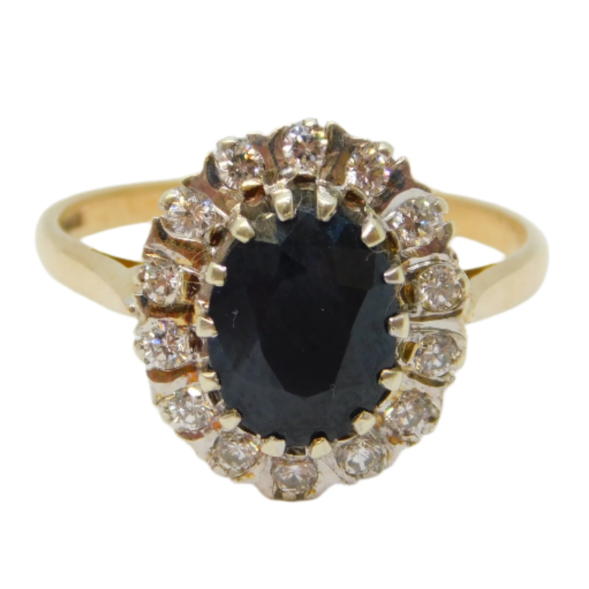 Gold ring with a black gemstone and diamond accents on a white background