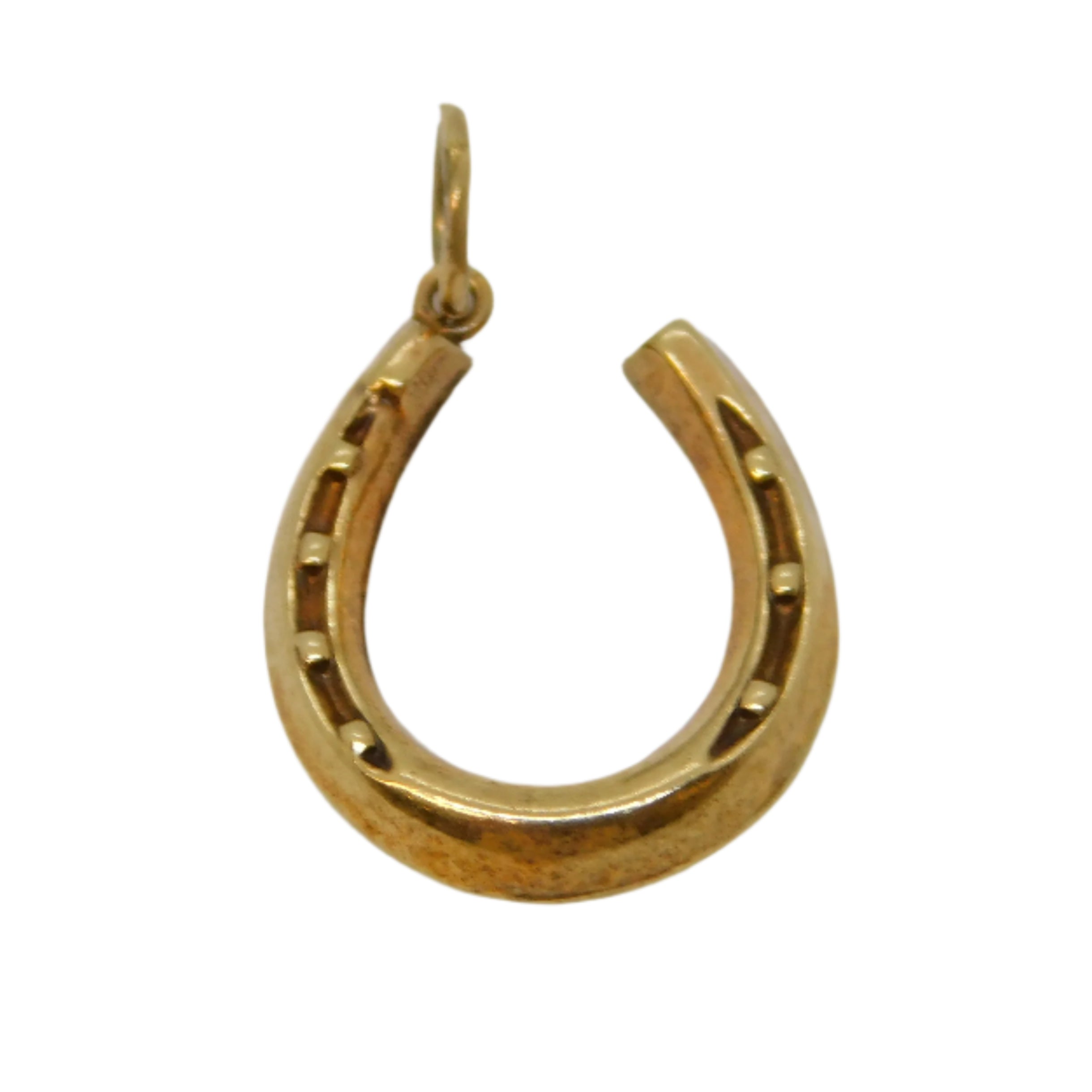 Gold horseshoe pendant on a light gray background