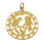 Gold pendant with intricate design on a light gray background