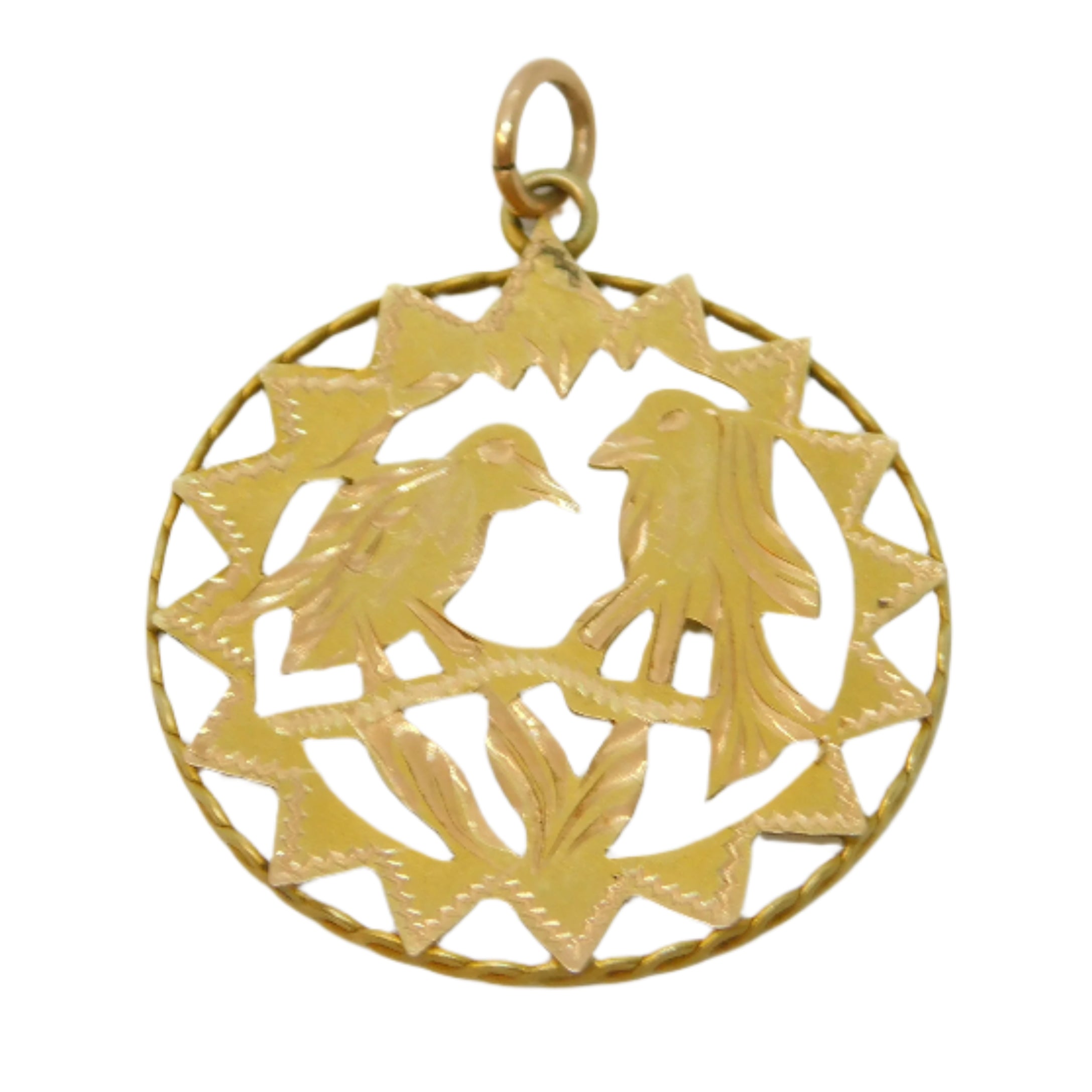 Gold pendant with intricate design on a light gray background