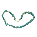 Turquoise beaded necklace on a white background