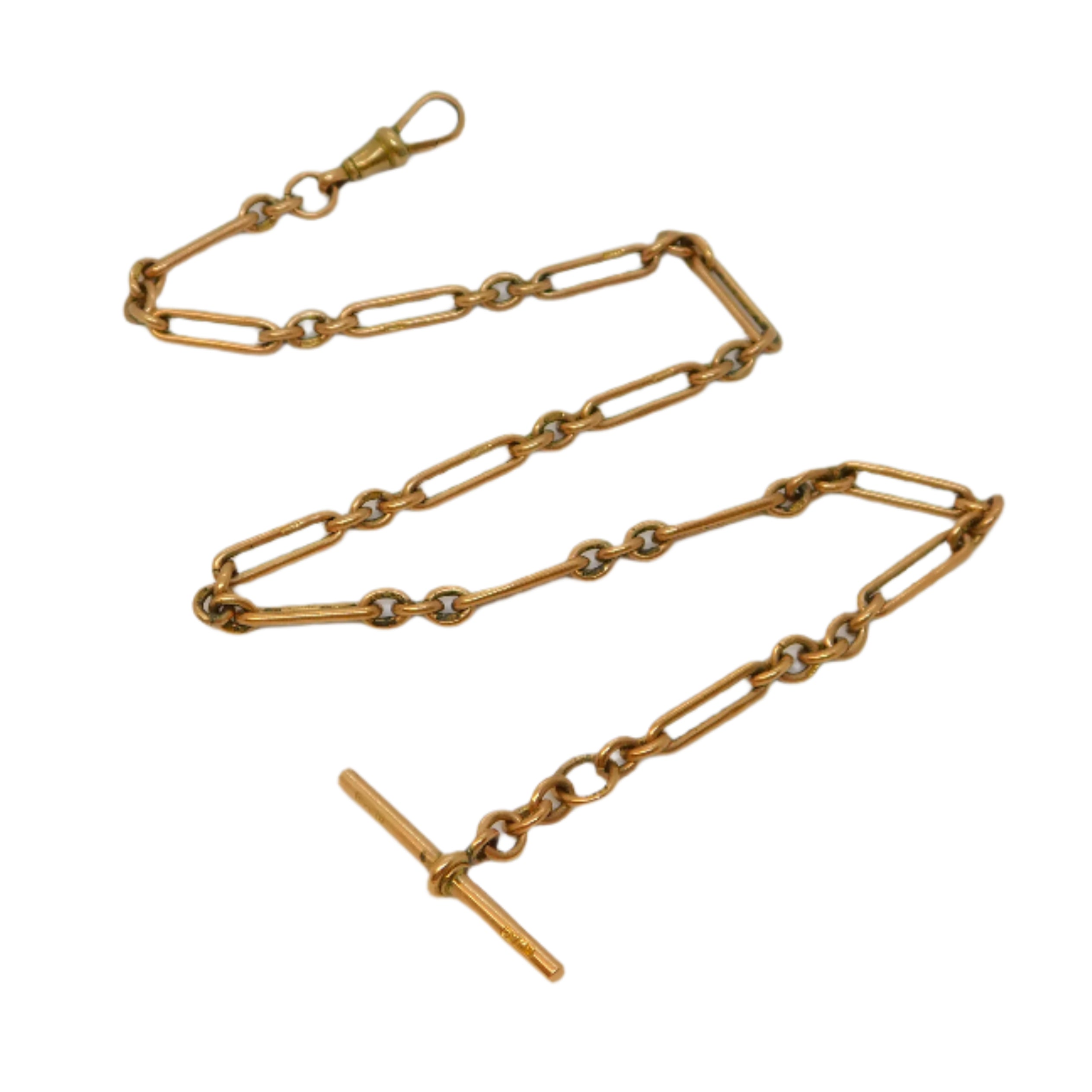 Gold chain necklace on a light gray background