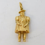 Gold pendant of a person on a white background
