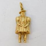 Gold pendant of a person on a white background
