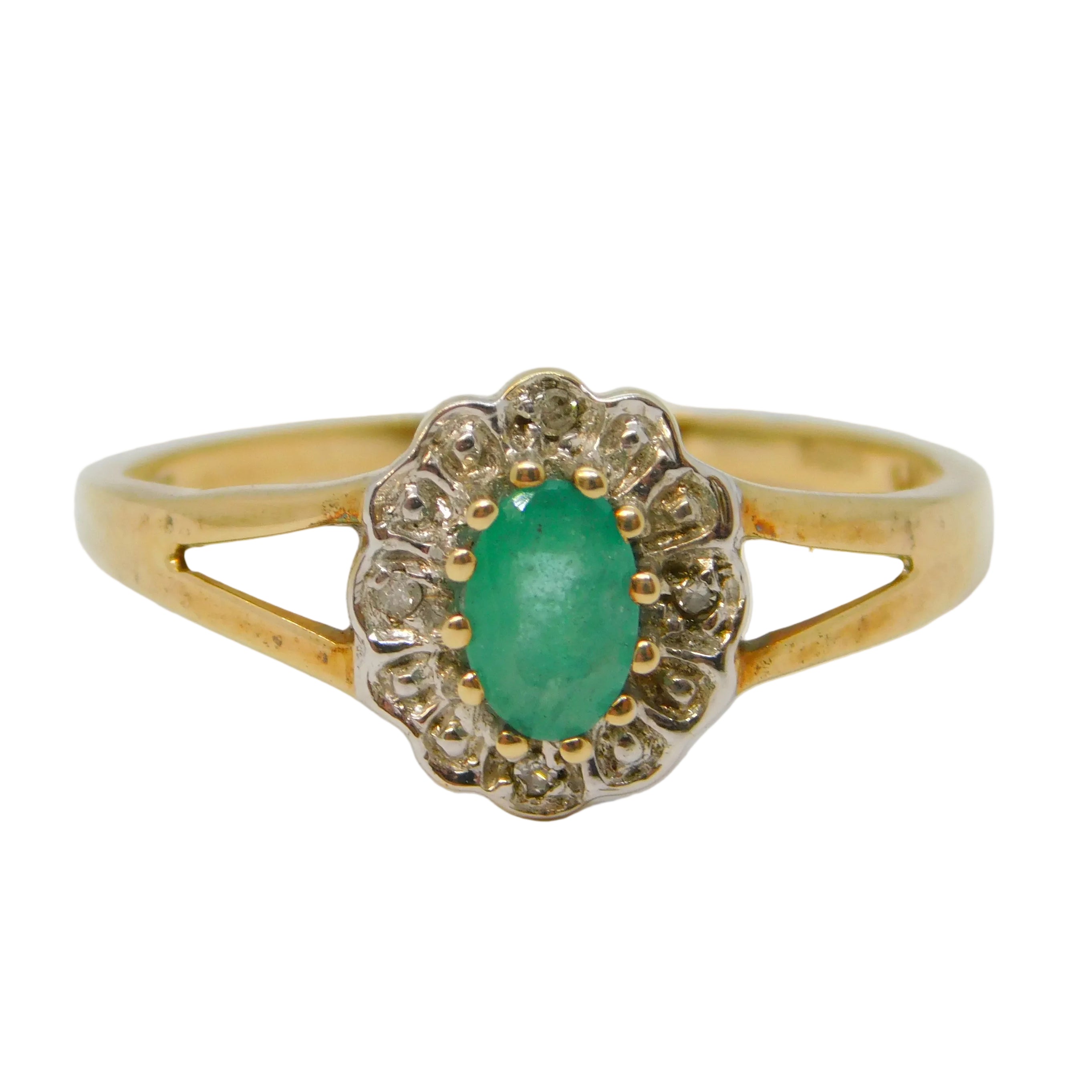 Gold ring with a green gemstone on a white background