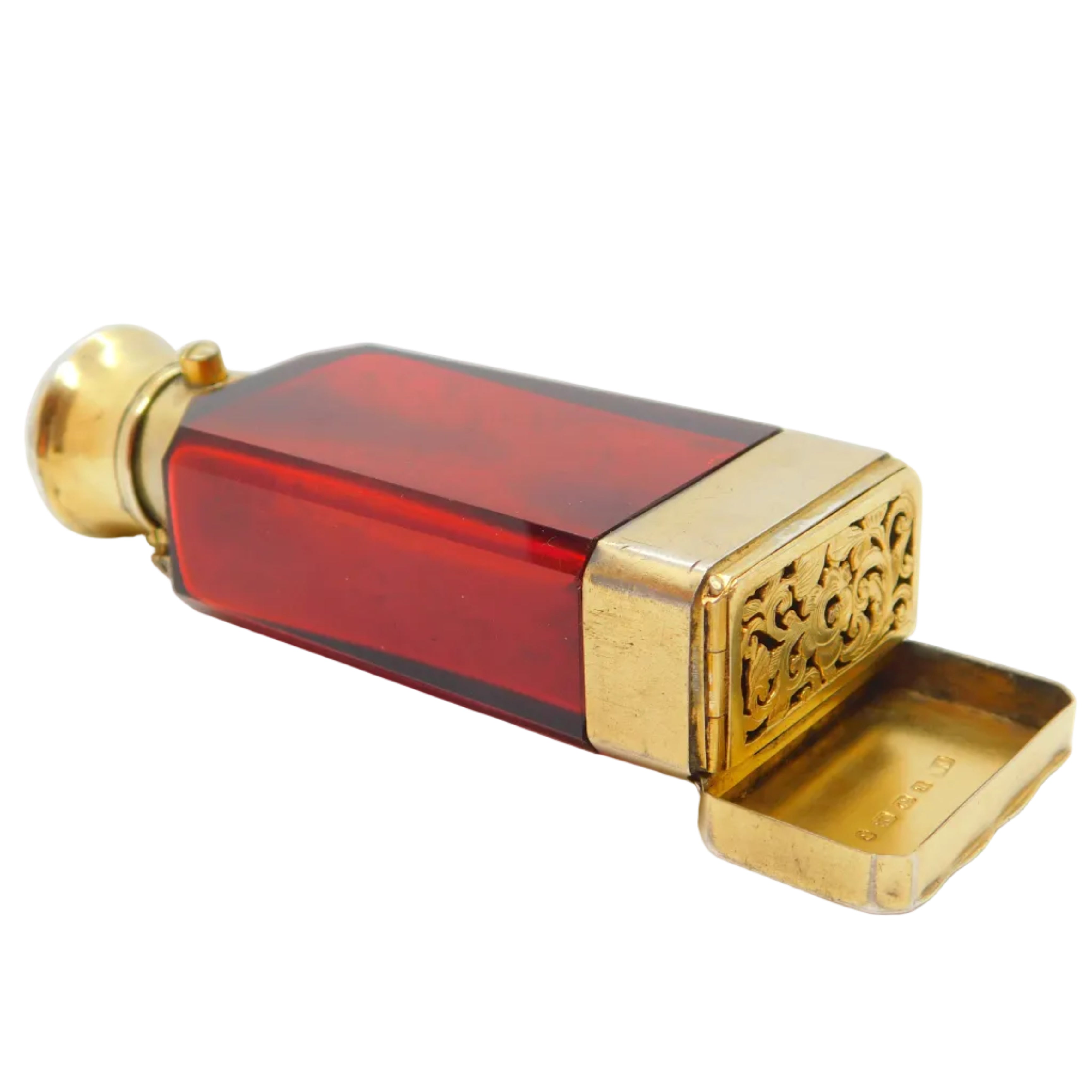 Antique Victorian sterling silver gilt and cranberry glass vinaigrette scent bottle with a silver cap and base, featuring intricate detailing and a cranberry tinted glass body.