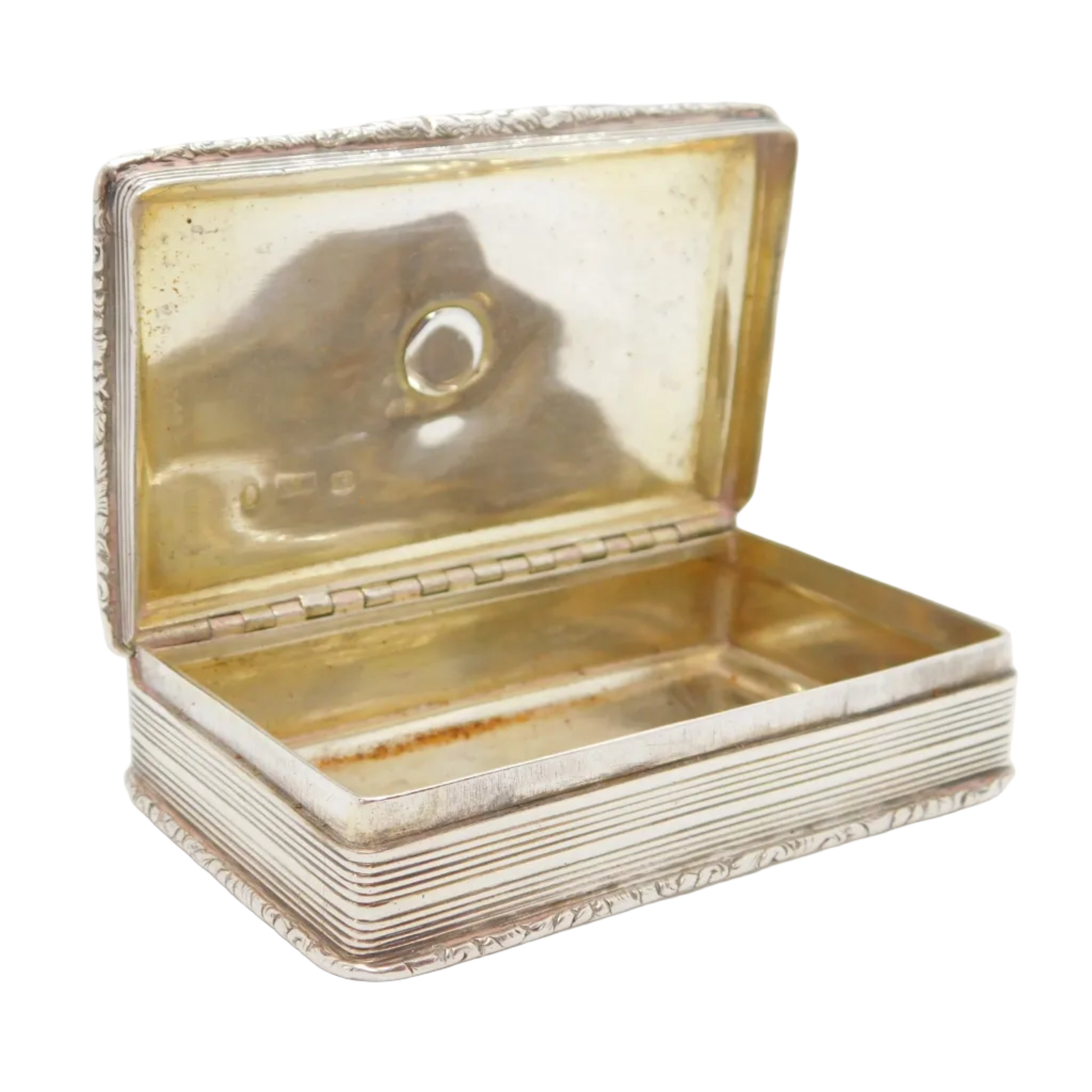 Antique sterling silver snuff box with a heraldic crest on the lid, floral patterns, and a reflective gold-toned finish.