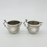 Pair Victorian Sterling Silver Cupid, Floral, Mythic Cream Jugs Antique 1900