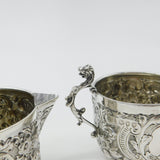 Pair Victorian Sterling Silver Cupid, Floral, Mythic Cream Jugs Antique 1900