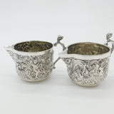 Pair Victorian Sterling Silver Cupid, Floral, Mythic Cream Jugs Antique 1900