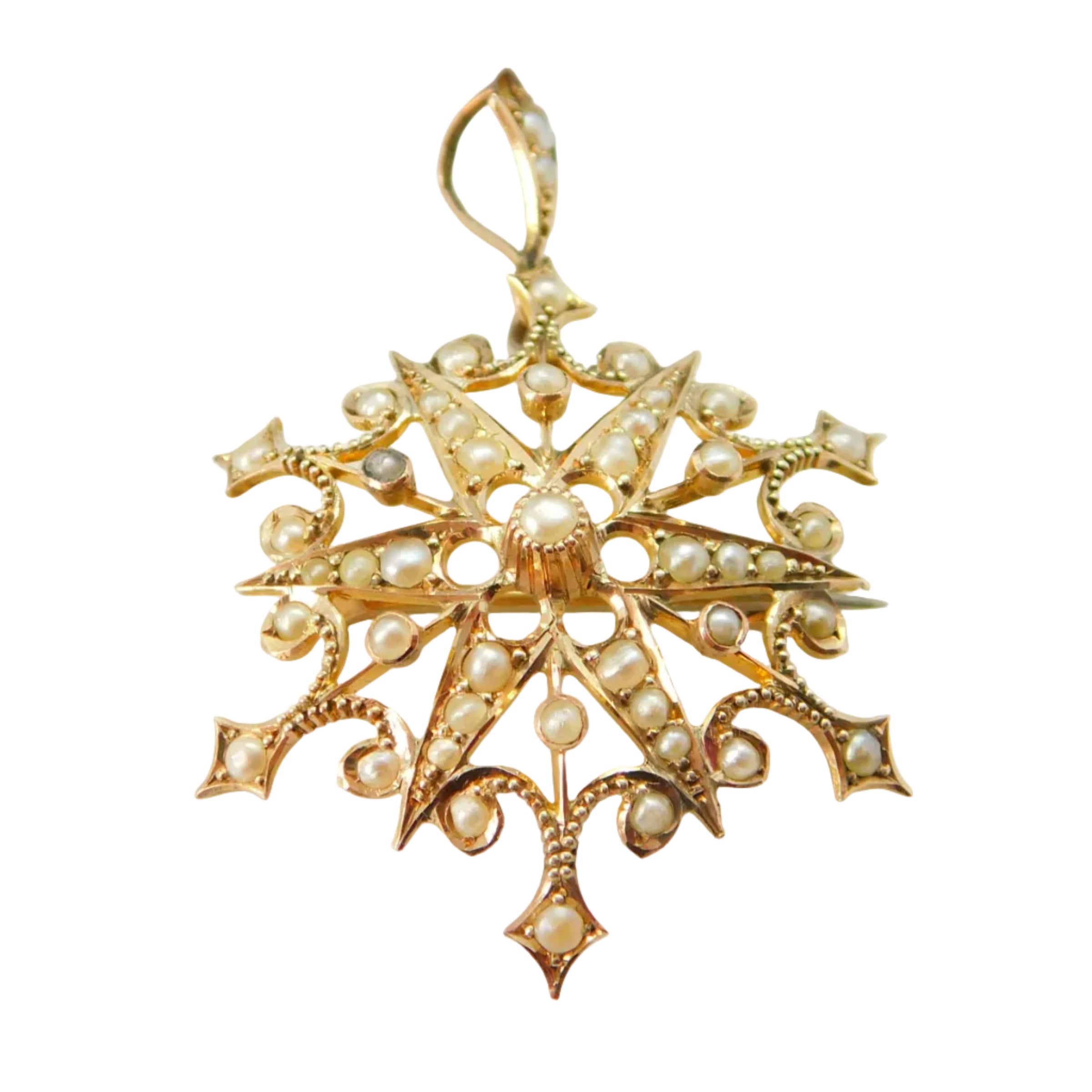 An image of an antique Edwardian 9ct yellow gold starburst drop pendant set with seed pearls, displayed against a white background with a brown box in the background.