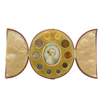 An antique oval portrait case with a hinged center panel holding a small painted portrait and surrounded by circular compartments containing coins or medallions, flanked by two fan-shaped inner panels, shown on a white background.