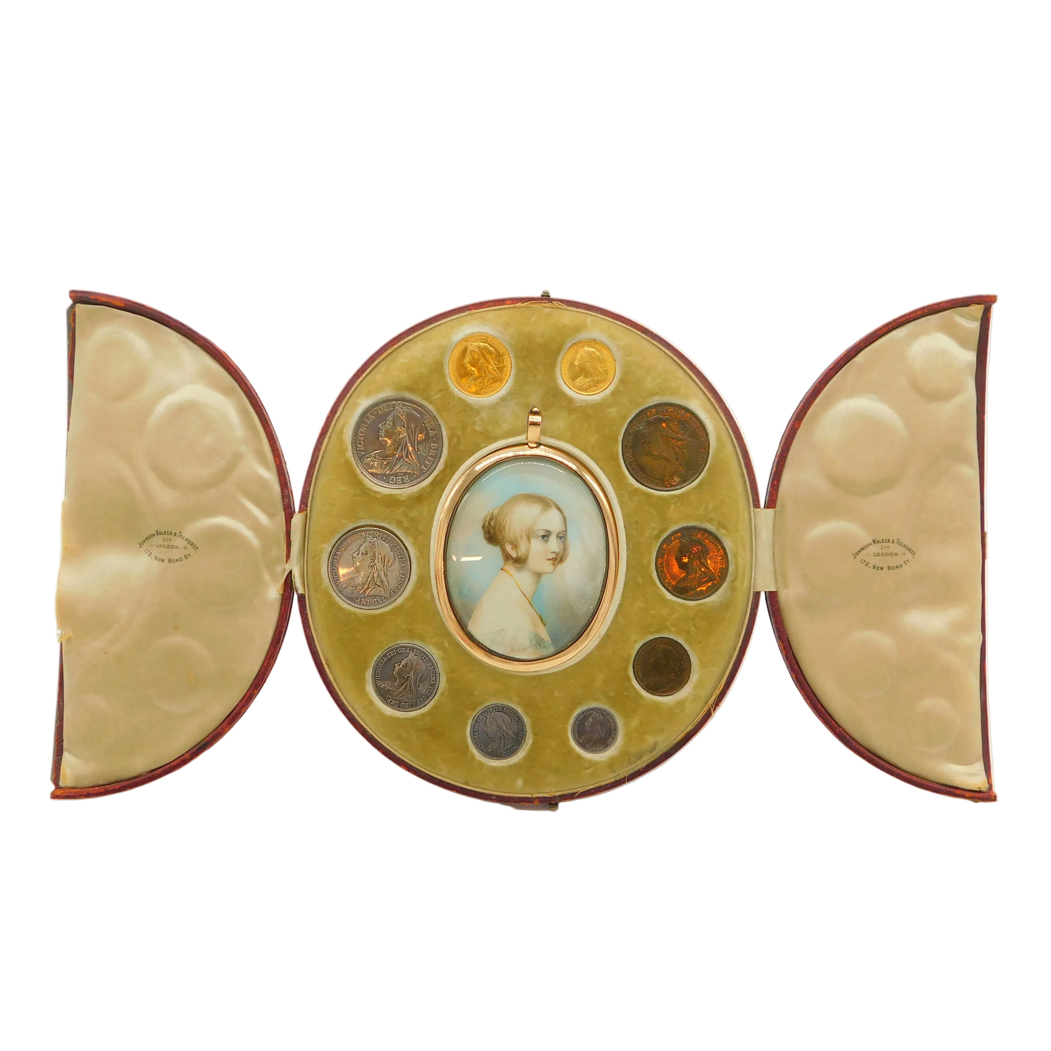 An antique oval portrait case with a hinged center panel holding a small painted portrait and surrounded by circular compartments containing coins or medallions, flanked by two fan-shaped inner panels, shown on a white background.