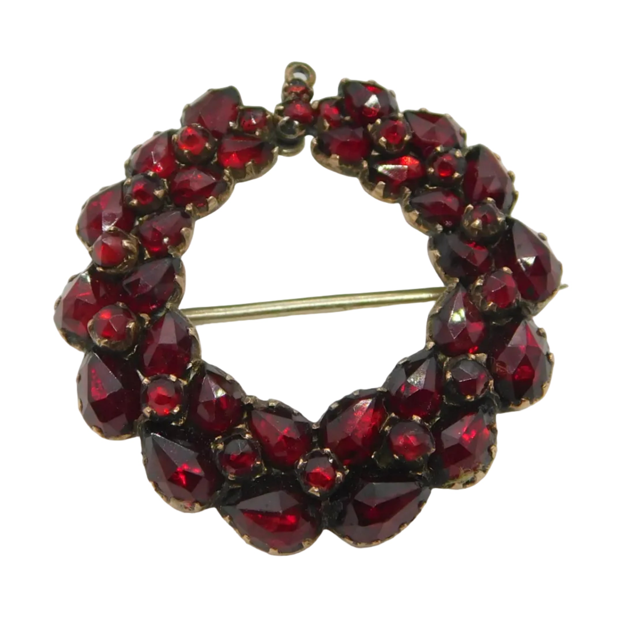 An antique Victorian 8ct rose gold bohemian garnet set floral wreath brooch, c1860, displayed against a white background