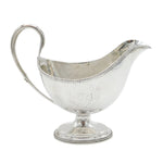 Silver gravy boat on a white background