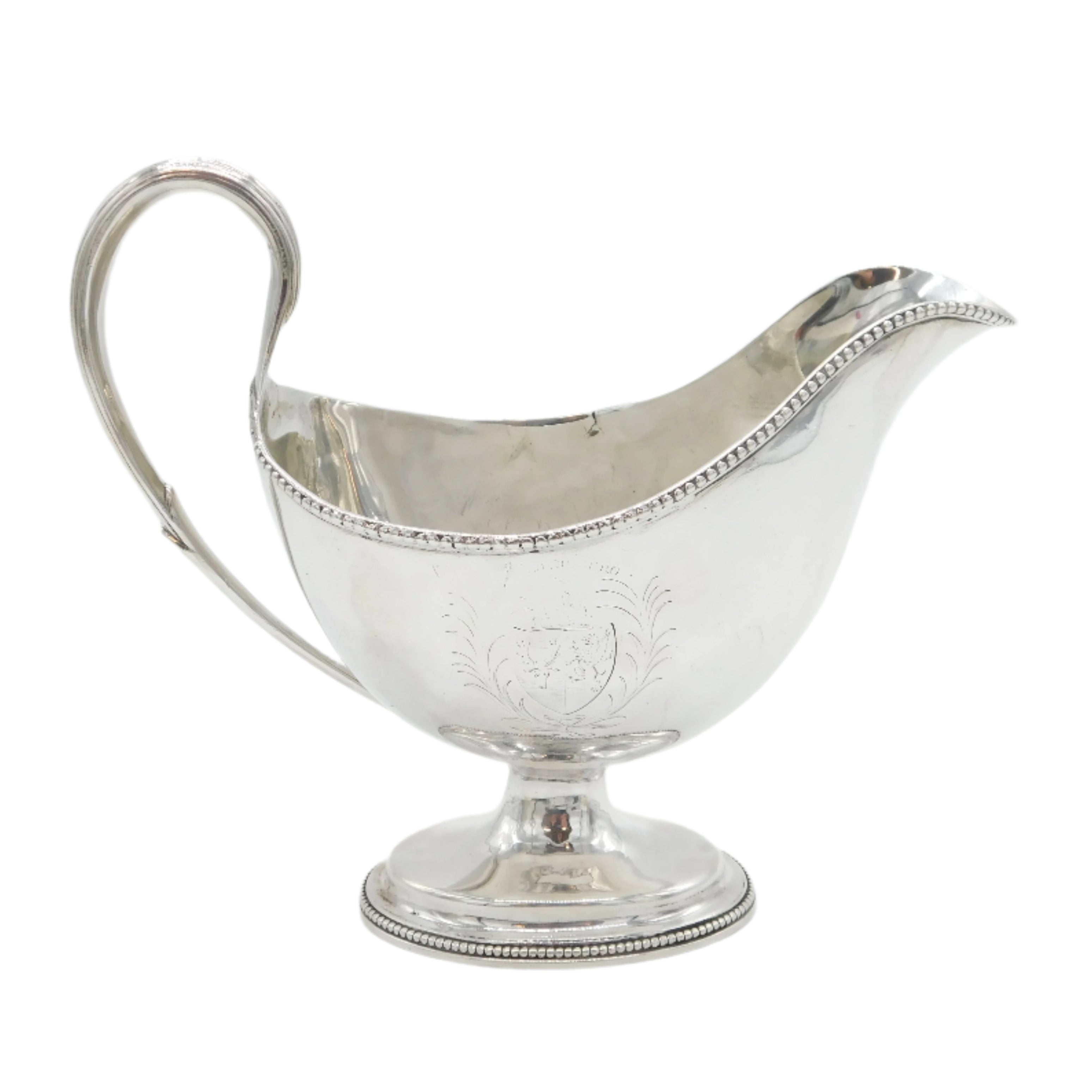Silver gravy boat on a white background