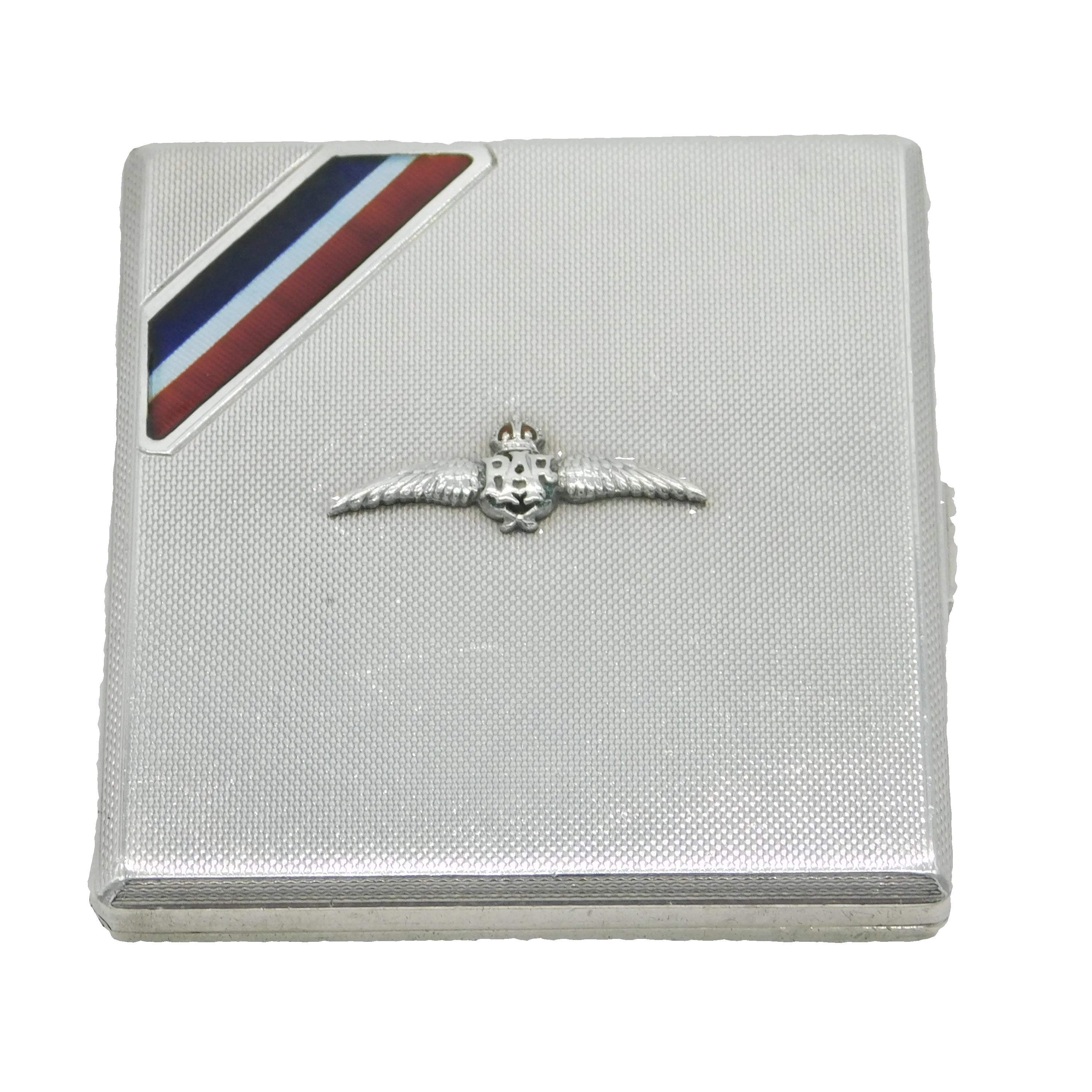 A WWII-era sterling silver and enamel RAF wings pilots cigarette case with French engraving, presented on a silver-colored box with a blue, white, and red enamel stripe.