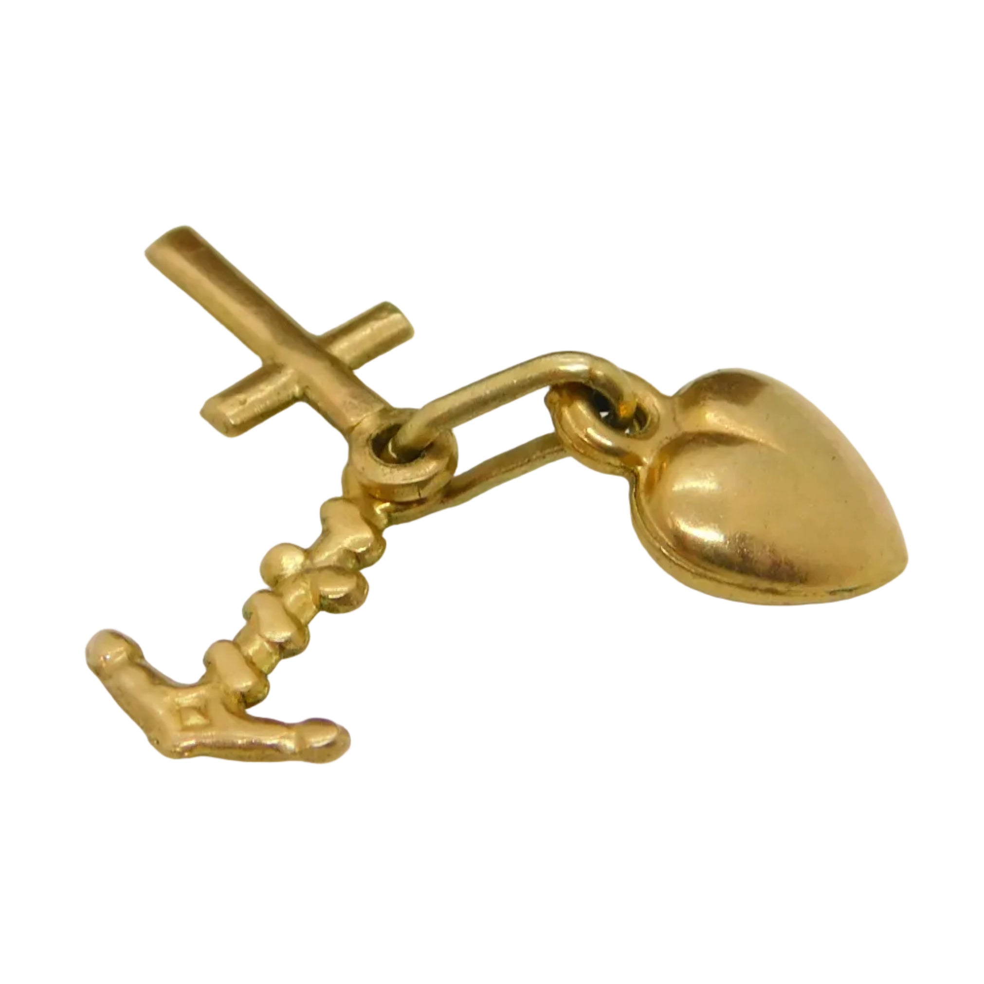 A 9ct yellow gold vintage charm pendant with a design representing the Faith, Hope, and Charity symbols, placed on a surface with a brown texture and a metallic clasp.
