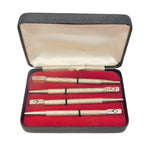 Set of three pens in a red-lined case on a white background