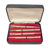 Set of three pens in a red-lined case on a white background